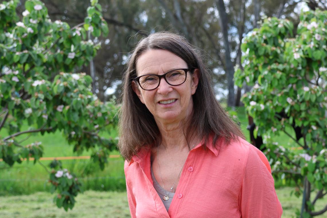 Alice Saville - a Community Worker standing outside in the garden. 